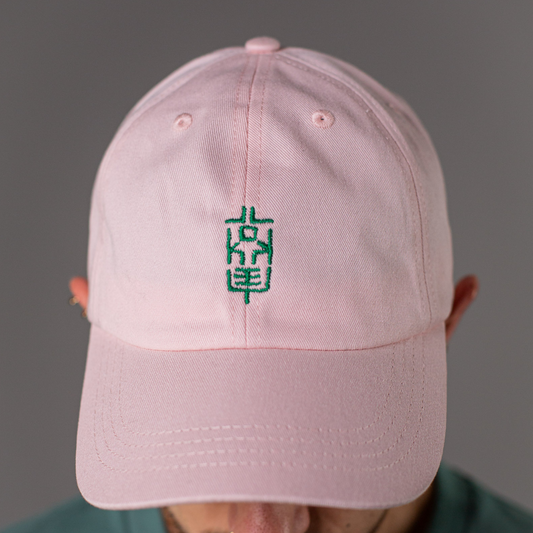 Zentral platzierte Nahaufnahme der pinkfarbenen Cap mit grünem LOKEY-Sticklogo, symmetrisch ausgerichtet, vollständig im Bild sichtbar.
